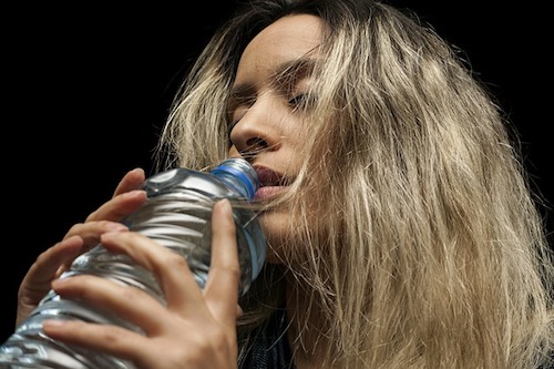 woman drinking bottled water