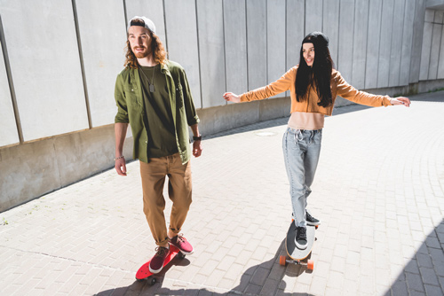 couple riding penny skateboards