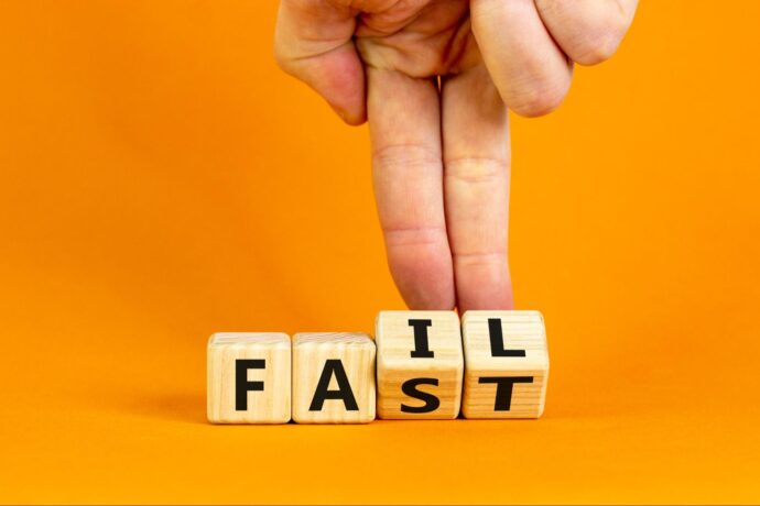 Someone making wooden blocks rollover to make the word fail.