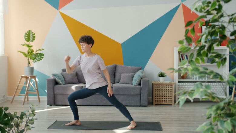 Woman exercising on yoga mat in living room.