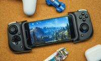 a game controller sitting next to a smart phone