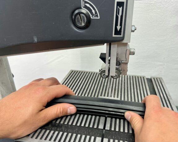 a person using a sewing machine to sew a piece of fabric